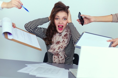 6 reasons why shopper marketing job is sou tough. Woman sitting a the desk pulling her hair out.